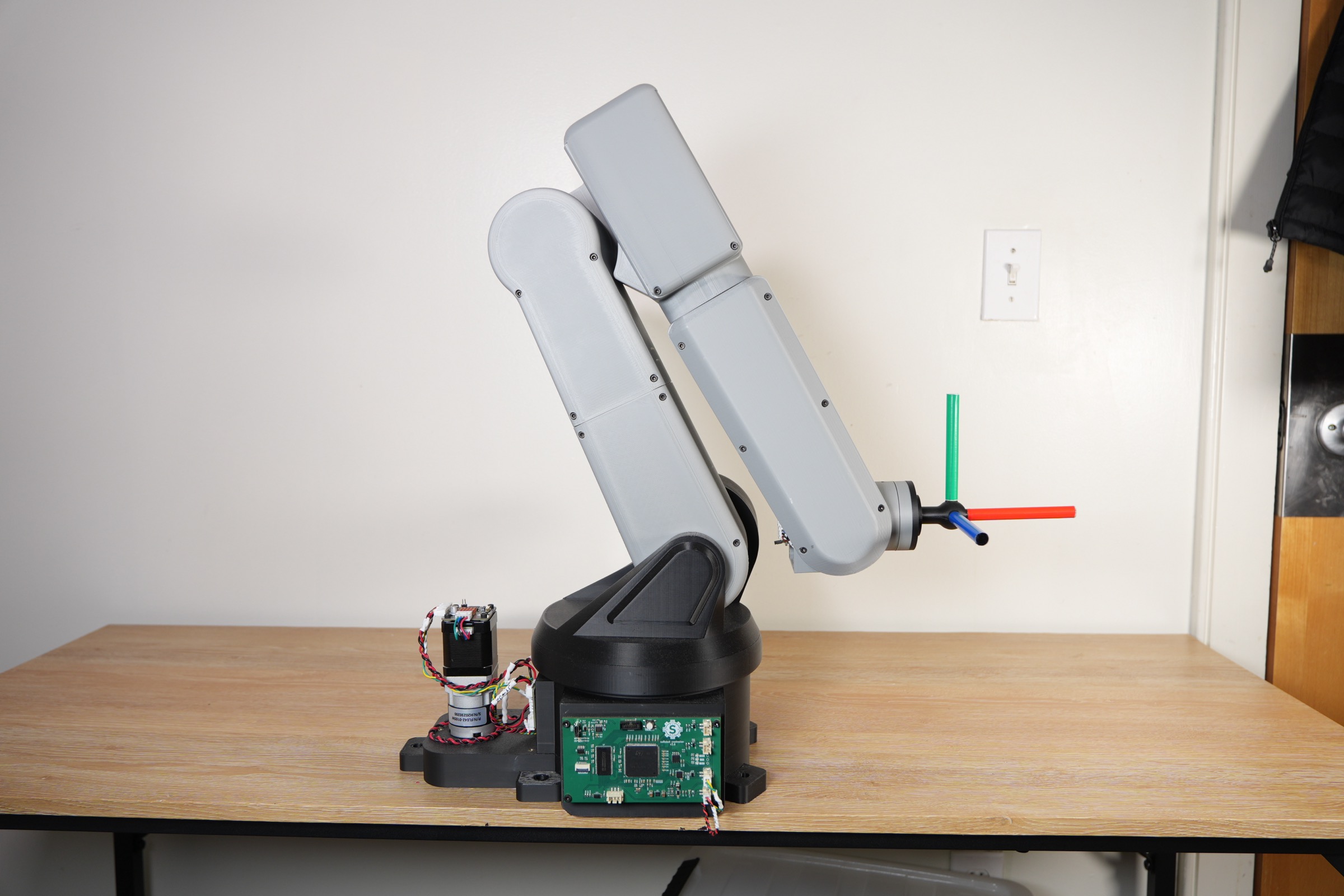 The 6DOF robot arm on a workbench with its robot controller mounted on the base