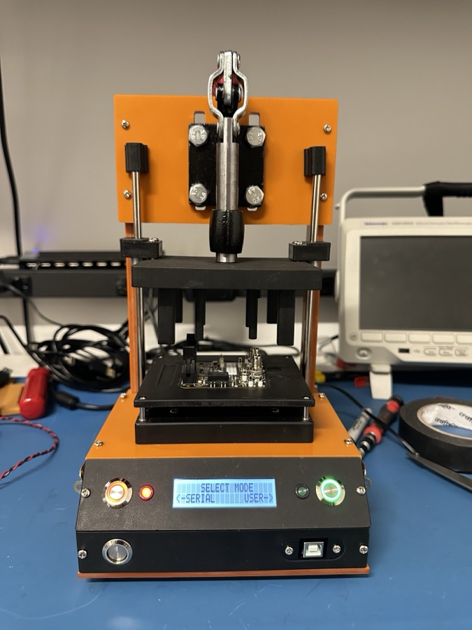 Finished fixture with a board loaded; LCD reads SELECT MODE