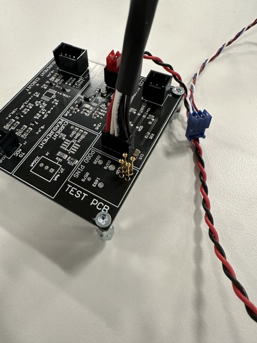 Black test PCB with connectors and a twisted-pair cable