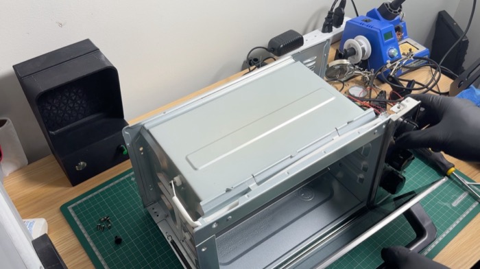 The oven shell stripped down on the bench