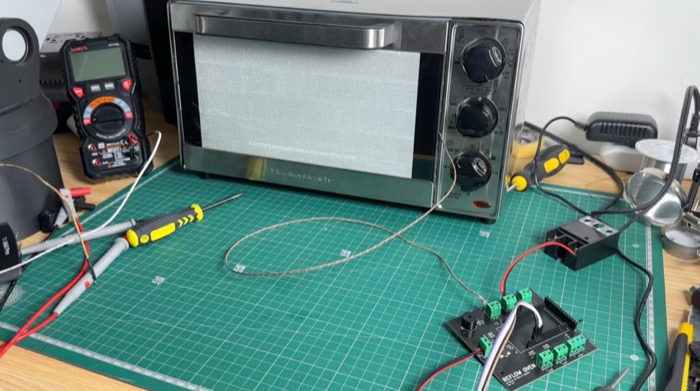 The oven with its insulated door, the temperature probe and the controller board on the bench