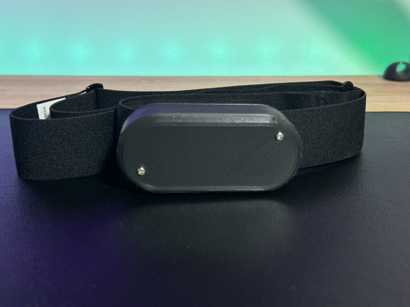 ECG chest strap with its oval 3D-printed enclosure
